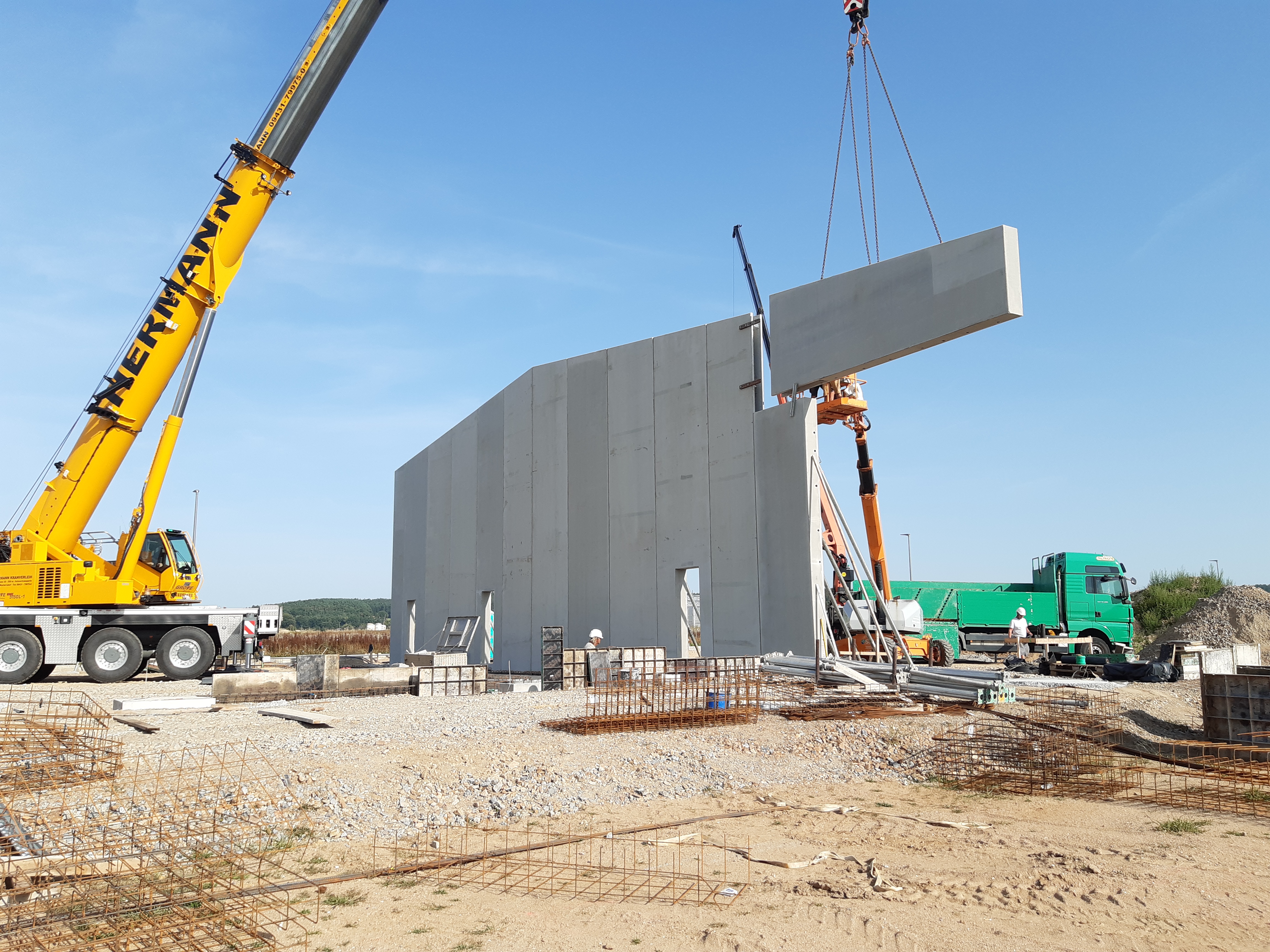 Hallenneubau in Nabburg – Versetzen einer 10 m hohen Doppelwand aus dem Werk der Sebald GmbH mit dem Autokran